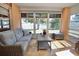 Bright sunroom with lake view and comfy seating at 9240 Tiara Ct, New Port Richey, FL 34655