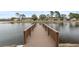 Wooden dock extending over calm lake water at 9316 Trowbridge Ct # 9316, New Port Richey, FL 34655