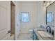 Updated bathroom with a vanity, shower, and window at 9694 Southern Belle Dr, Weeki Wachee, FL 34613