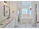 Elegant bathroom with granite countertops and a soaking tub at 9694 Southern Belle Dr, Weeki Wachee, FL 34613