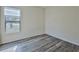 Bright bedroom with wood-look flooring and large window at 9694 Southern Belle Dr, Weeki Wachee, FL 34613