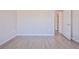 Bedroom with wood-look floors and an open door to hallway at 9694 Southern Belle Dr, Weeki Wachee, FL 34613