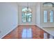 Spacious dining room featuring hardwood floors and large windows at 9694 Southern Belle Dr, Weeki Wachee, FL 34613