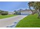 One story house with a large driveway and green grass at 9694 Southern Belle Dr, Weeki Wachee, FL 34613