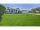 House with a large front yard and palm trees at 9694 Southern Belle Dr, Weeki Wachee, FL 34613