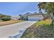 One story house with a large driveway and green grass at 9694 Southern Belle Dr, Weeki Wachee, FL 34613