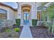 Elegant front door entrance with double doors and sidelights at 9694 Southern Belle Dr, Weeki Wachee, FL 34613