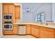 Kitchen with light wood cabinets and stainless steel appliances at 9694 Southern Belle Dr, Weeki Wachee, FL 34613