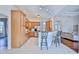 Kitchen with light wood cabinets, stainless steel appliances, and breakfast bar at 9694 Southern Belle Dr, Weeki Wachee, FL 34613