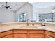 Kitchen with light wood cabinets, double sink, and views to living area at 9694 Southern Belle Dr, Weeki Wachee, FL 34613