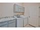 Laundry room with washer, dryer, cabinets, and a sink at 9694 Southern Belle Dr, Weeki Wachee, FL 34613