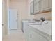 Laundry room with washer, dryer, cabinets, and a sink at 9694 Southern Belle Dr, Weeki Wachee, FL 34613