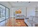 Open living room with kitchen view and wood floors at 9694 Southern Belle Dr, Weeki Wachee, FL 34613