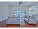 Bright living room with hardwood floors, sliding glass doors, and comfy sofas at 9694 Southern Belle Dr, Weeki Wachee, FL 34613