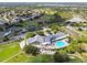 Beautiful aerial view of the community center featuring a swimming pool, tennis courts, and a golf course at 11637 Spindrift Loop, Hudson, FL 34667