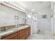 Bright bathroom with a double sink, and a glass enclosed shower at 11637 Spindrift Loop, Hudson, FL 34667