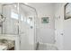 Bright bathroom with a glass enclosed shower, a window, and neutral colored walls at 11637 Spindrift Loop, Hudson, FL 34667