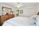 Comfortable bedroom featuring a ceiling fan, a large dresser, and closet at 11637 Spindrift Loop, Hudson, FL 34667