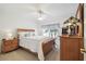 Comfortable bedroom featuring a ceiling fan, and a stained glass lamp on a dresser at 11637 Spindrift Loop, Hudson, FL 34667