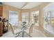 Cozy breakfast nook with large windows, natural light, and seating for four at 11637 Spindrift Loop, Hudson, FL 34667