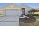 Charming single-story home featuring a well-manicured lawn and a two-car garage at 11637 Spindrift Loop, Hudson, FL 34667
