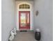 Inviting entryway with decorative glass door, brickwork, and charming decor at 11637 Spindrift Loop, Hudson, FL 34667