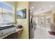 Eat-in kitchen area with a bay window and stainless steel refrigerator at 11637 Spindrift Loop, Hudson, FL 34667