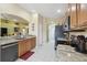 Well-lit kitchen featuring granite countertops, stainless steel appliances and tile flooring at 11637 Spindrift Loop, Hudson, FL 34667