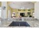 Modern kitchen with granite countertops and stainless steel appliances, open to the living area at 11637 Spindrift Loop, Hudson, FL 34667