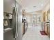 Open kitchen layout with stainless steel refrigerator and sunny breakfast nook at 11637 Spindrift Loop, Hudson, FL 34667
