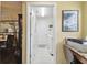 Bright laundry room features a white washer and dryer and leads to additional storage space at 11637 Spindrift Loop, Hudson, FL 34667