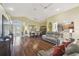 Open-concept living area with wood floors flowing into the dining room and kitchen at 11637 Spindrift Loop, Hudson, FL 34667