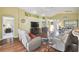 Open-concept living area with wood floors and access to kitchen, bedroom, and dining room at 11637 Spindrift Loop, Hudson, FL 34667