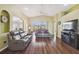 Open living room with wood floors, vaulted ceilings, and sliding doors to the lanai at 11637 Spindrift Loop, Hudson, FL 34667