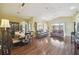 Open-concept living and dining area featuring hardwood floors and plenty of natural light at 11637 Spindrift Loop, Hudson, FL 34667