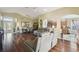Open-concept living area with wood floors flowing into the dining room and kitchen at 11637 Spindrift Loop, Hudson, FL 34667