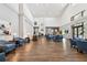 Bright lobby features comfortable blue chairs, stylish decor, and wood-look flooring at 11637 Spindrift Loop, Hudson, FL 34667