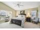 Comfortable main bedroom featuring a ceiling fan and a large window for natural light at 11637 Spindrift Loop, Hudson, FL 34667