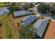 Aerial view of homes featuring mature trees and lush surroundings, providing a serene setting at 11744 Wheatfield Loop, Hudson, FL 34667