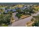 Aerial view of a golf course clubhouse with lush landscaping and abundant parking at 11744 Wheatfield Loop, Hudson, FL 34667