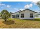 Spacious backyard of the home with a well-kept lawn and back patio at 11744 Wheatfield Loop, Hudson, FL 34667