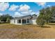 Large backyard featuring a screened in back patio, perfect for relaxing and entertaining at 11744 Wheatfield Loop, Hudson, FL 34667