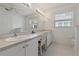 Bathroom with double sinks, bright lighting, and vanity with ample counter space at 11744 Wheatfield Loop, Hudson, FL 34667
