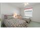 Bright guest bedroom with two twin beds and floral bedding at 11744 Wheatfield Loop, Hudson, FL 34667
