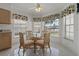 Breakfast nook with a glass table and seating for four near bright windows at 11744 Wheatfield Loop, Hudson, FL 34667