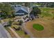 Aerial view of community clubhouse with an abundance of golf cart parking at 11744 Wheatfield Loop, Hudson, FL 34667