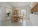 Well-lit dining area with round table, chandelier, and window views at 11744 Wheatfield Loop, Hudson, FL 34667