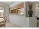 Bright dining area next to kitchen featuring tiled floors and decorative vase at 11744 Wheatfield Loop, Hudson, FL 34667