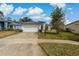 Traditional style home with a two car garage and concrete driveway at 11744 Wheatfield Loop, Hudson, FL 34667