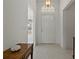Bright foyer with tile flooring and a glass insert front door at 11744 Wheatfield Loop, Hudson, FL 34667
